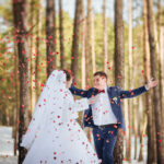 Happy bride and groom in winter day on their wedding, photo session.